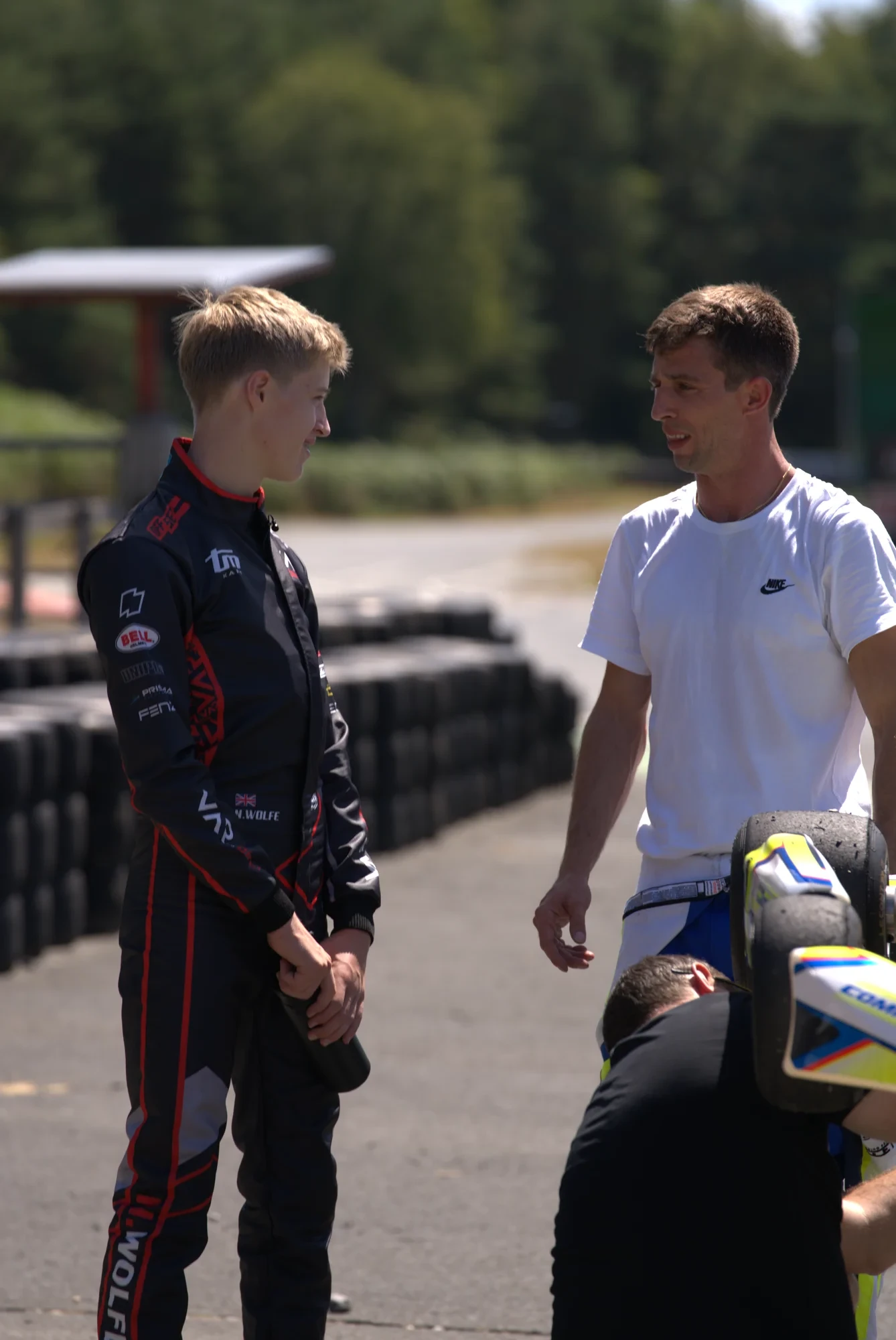 Driver and coach discussing trackside
